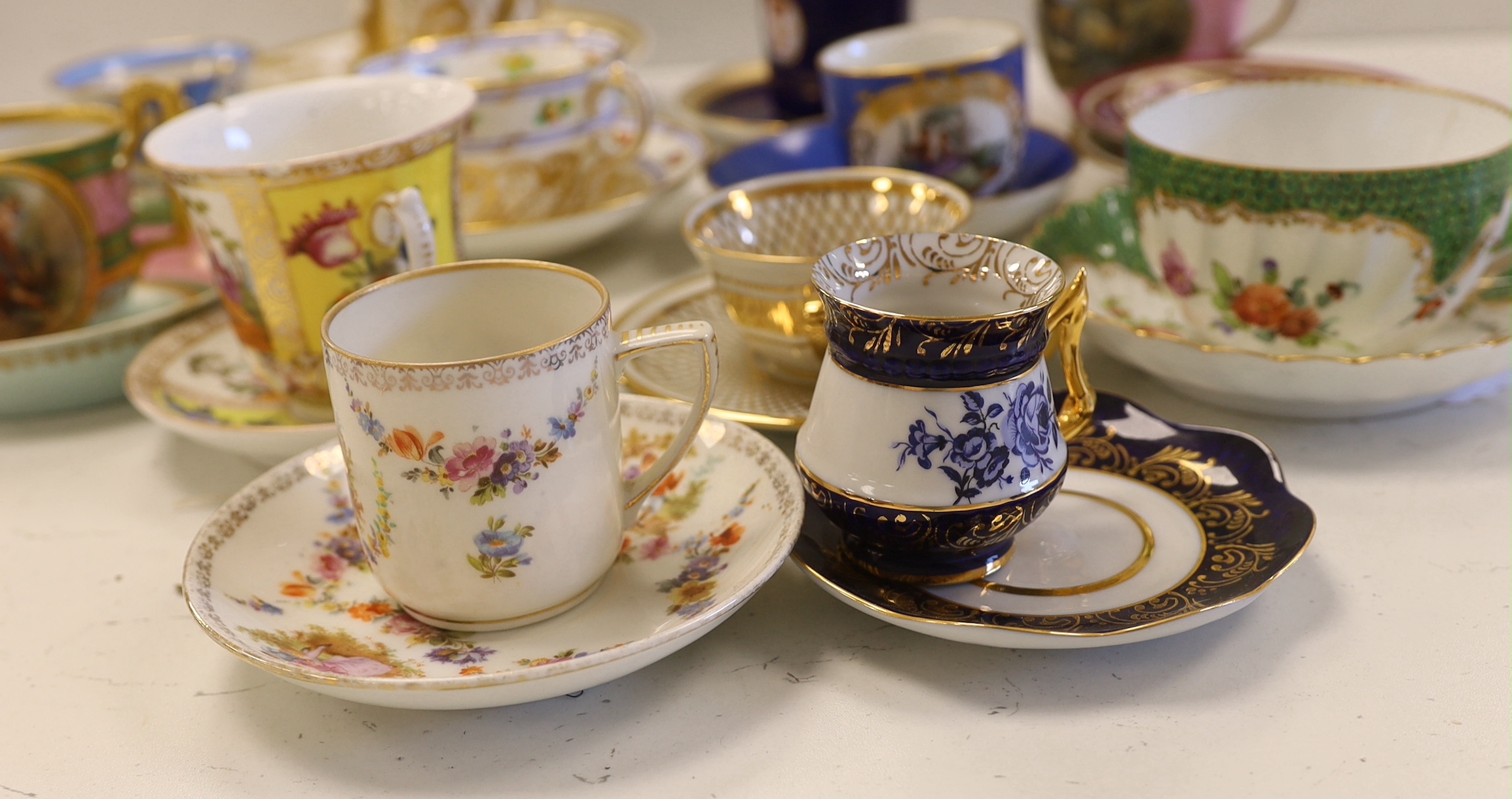 A collection of European cabinet cups and saucers, including a gilded Berlin cup and saucer (12)